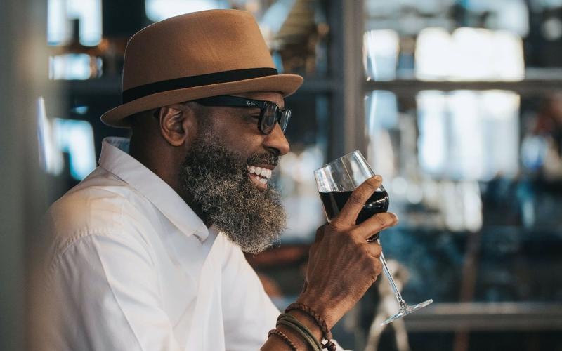 man sitting with a glass of wine in his hand